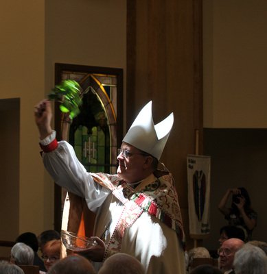 Bishop Ted Gulick sprinkles holy water over the congregation during the dedication service