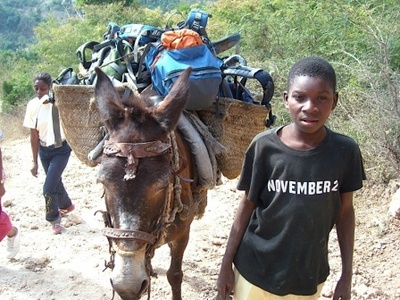 Villagers help carry supplies and equipment
