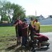 Boy Scouts help erect the hoop