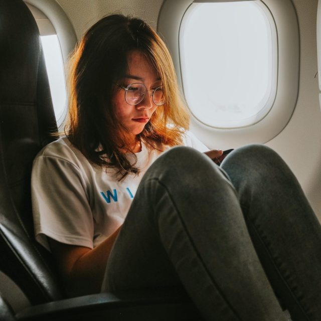 girl on cellphone in airplane e1606056109428.jpeg