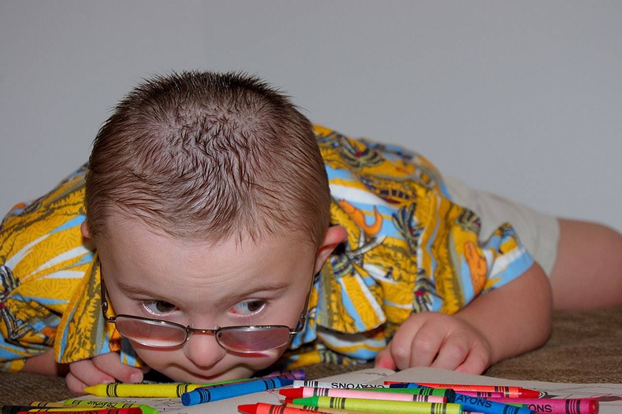 special needs boy with crayons