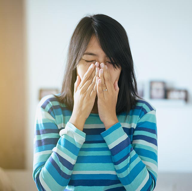 Girl sneezing from allergies in Burnsville, Minnesota,