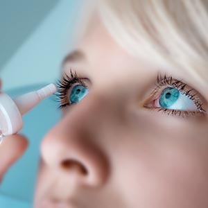 Eye Care, Woman putting eye drops in her eyes in Burnsville, Minnesota,