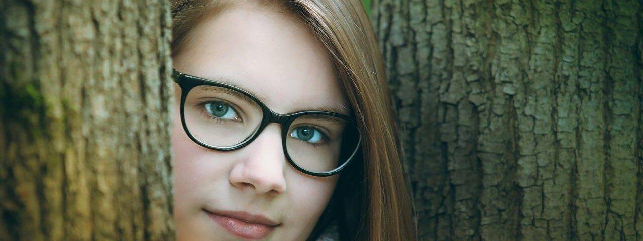 Woman, in woods, wearing eyeglasses