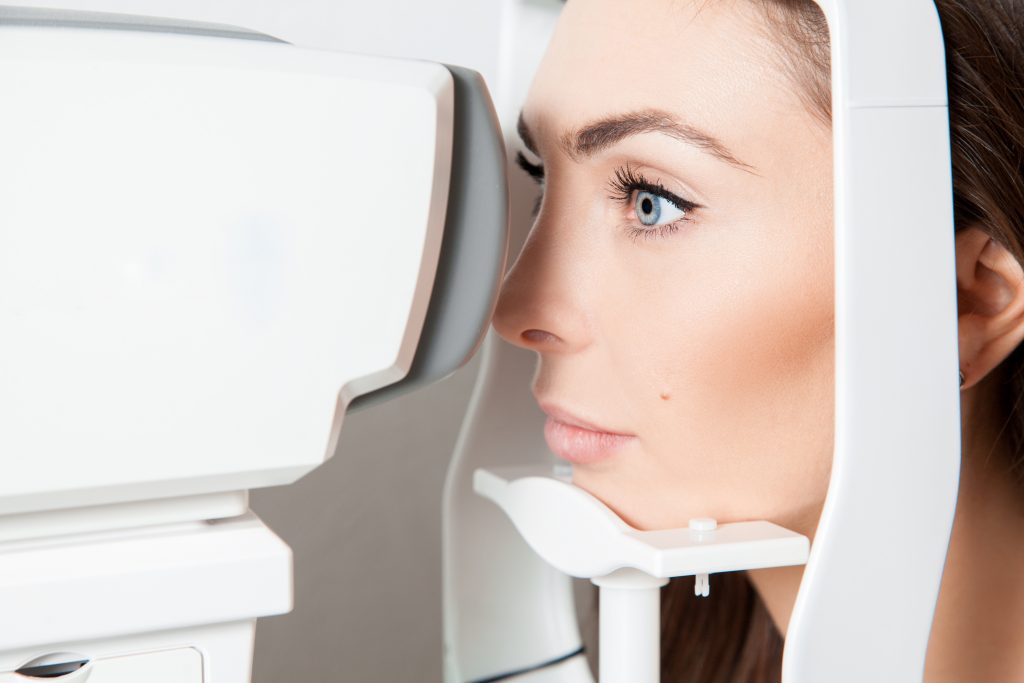 young adult brunette looking at eye test machine in ophtha