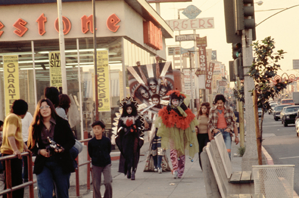 Asco, <em>Walking Mural</em>, 1972. Colour photograph. Photograph: Harry Gamboa, Jr, showing Patssi Valdez, Willie Herrón III and Gronk. Asco, <em>Walking Mural</em>, 1972. Colour photograph. Photograph: Harry Gamboa, Jr, showing Patssi Valdez, Willie Herrón III and Gronk.