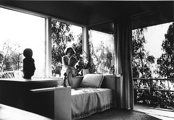 Galka Scheyer in her Hollywood Hills house designed by Richard Neutra. Lette Vaselka, <em>Galka Scheyer in Sunsuit, Seated on Windowsill</em>, ca. 1940-43. Photograph, 3 1/2 x 4 3/4 in. Courtesy of the Blue Four Galka Scheyer Collection Archives, Norton Simon Museum, Pasadena, CA. 