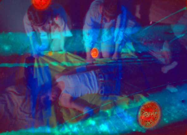Jennifer West, <em>Daisies Roll Up Film (16mm color and b&w film neg rolled with hard boiled eggs, oranges, lemons, avocados, pickles, green apples, milk and watermelon – a remake of a scene from Vera Chytilova’s 1966 film, Daisies – rolling off the bed performances by: Mariah Csepanyi, Finn West & Jwest, lit with black light & strobe light)</em>, 2008. 5 min, 53 sec. All images courtesy of MARC FOXX, Los Angeles. Jennifer West, <em>Daisies Roll Up Film (16mm color and b&w film neg rolled with hard boiled eggs, oranges, lemons, avocados, pickles, green apples, milk and watermelon – a remake of a scene from Vera Chytilova’s 1966 film, Daisies – rolling off the bed performances by: Mariah Csepanyi, Finn West & Jwest, lit with black light & strobe light)</em>, 2008. 5 min, 53 sec. All images courtesy of MARC FOXX, Los Angeles.
