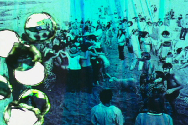 Jennifer West, <em>Topanga Beach Houses Imminent Domain Rewind Film (16mm film print rubbed with aloe vera gel, smeared with Sex Wax surfboard wax, butter, grass, hole punched - still photos of the Topanga Beach community in the 1960's and 70's before the houses were bulldozed and burned with the Imminent Domain Law - movie stills from "Muscle Beach" and "Cosmic Children" - found photographs from the Int'l Surfing Magazine (Jim Fitzpatrick), Malibu Times (Gary Graham), Marlies Armand, Jeff Ort, Woody Stuart and John Clemmens)</em>, 2010. 2 min, 47 sec. Jennifer West, <em>Topanga Beach Houses Imminent Domain Rewind Film (16mm film print rubbed with aloe vera gel, smeared with Sex Wax surfboard wax, butter, grass, hole punched - still photos of the Topanga Beach community in the 1960's and 70's before the houses were bulldozed and burned with the Imminent Domain Law - movie stills from "Muscle Beach" and "Cosmic Children" - found photographs from the Int'l Surfing Magazine (Jim Fitzpatrick), Malibu Times (Gary Graham), Marlies Armand, Jeff Ort, Woody Stuart and John Clemmens)</em>, 2010. 2 min, 47 sec.