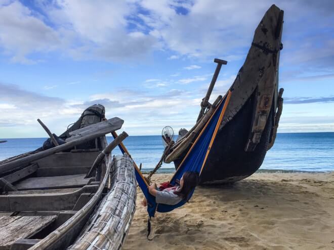 sitting in a portable serac camping hammock on the beach. enjoying the view hanging from 2 boats in a serac sequoia daybreak orange blue color sitting in a portable serac camping hammock on the beach. enjoying the view hanging from 2 boats in a serac sequoia daybreak orange blue color