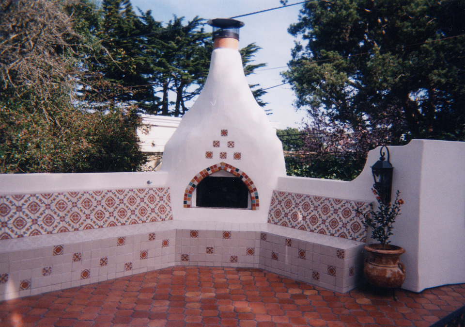 stucco and stone classic spanish cuerda seca outdoor fireplace tile design