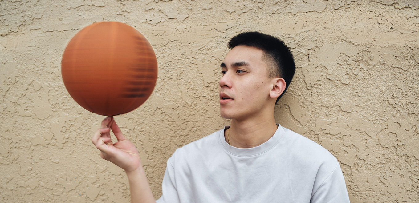 Alex spins a basketball on his finger