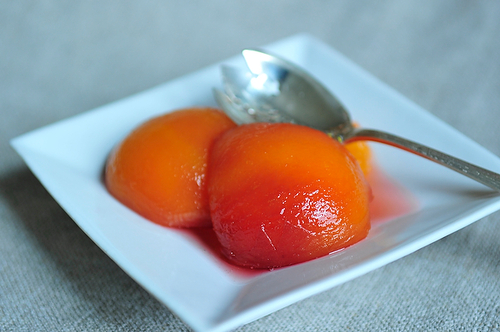 Poached peaches in wine and basil