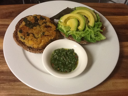 Vegan garbanzo bean burger with spinach, sun-dried tomatoes and chimichurri sauce
