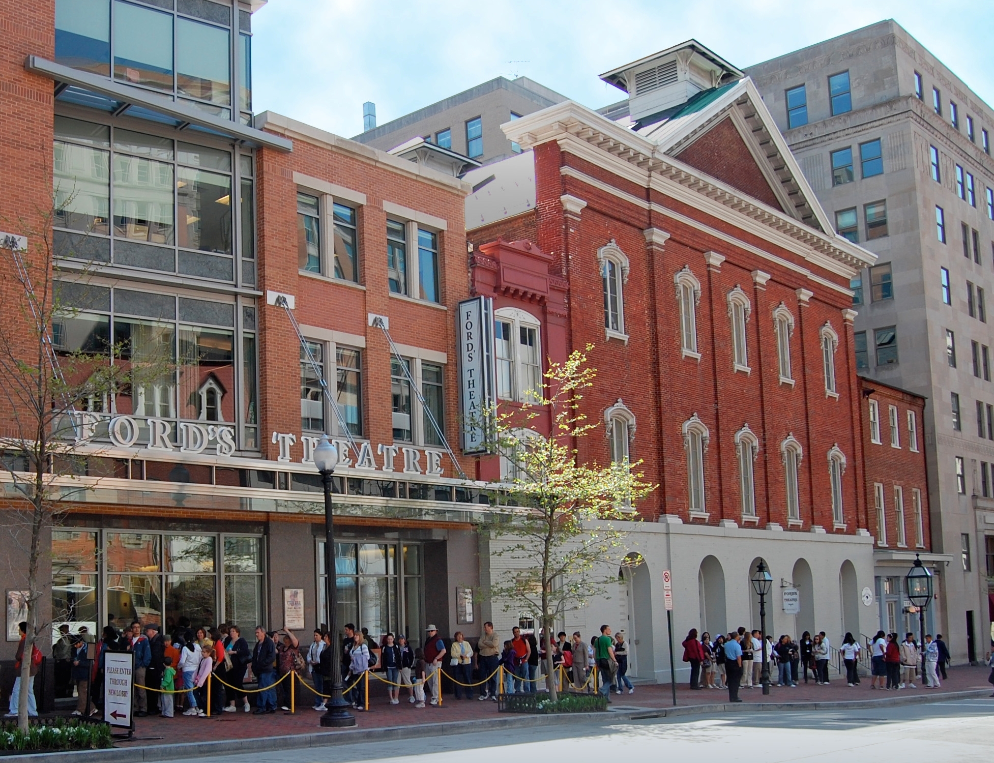 Photo of the Ford's Exterior. A line of people waiting to enter Ford's stretches down the entire block.