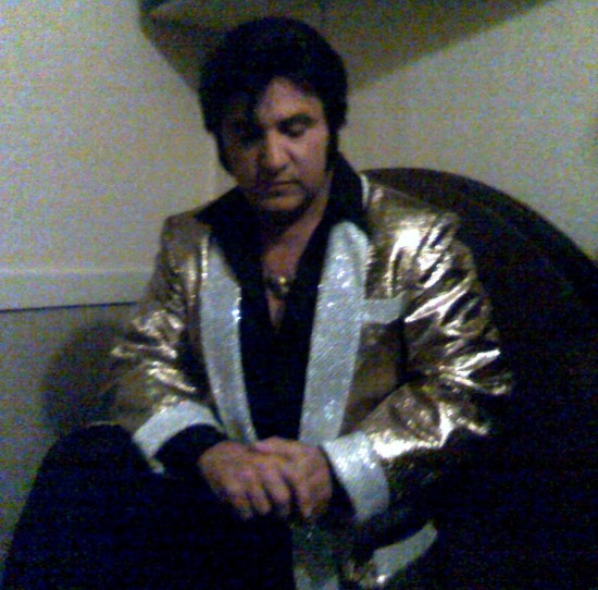 Bay Area's #1 elvis Impersonator Rick Torres in 1956 Rock a Billy attire taking a minute for prayer