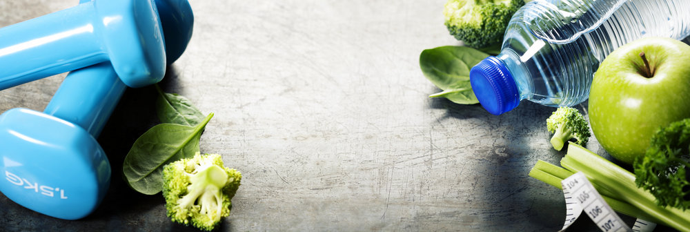 Fresh healthy vegetables, water and measuring tape. Health and d exercise dumbells and green vegetables