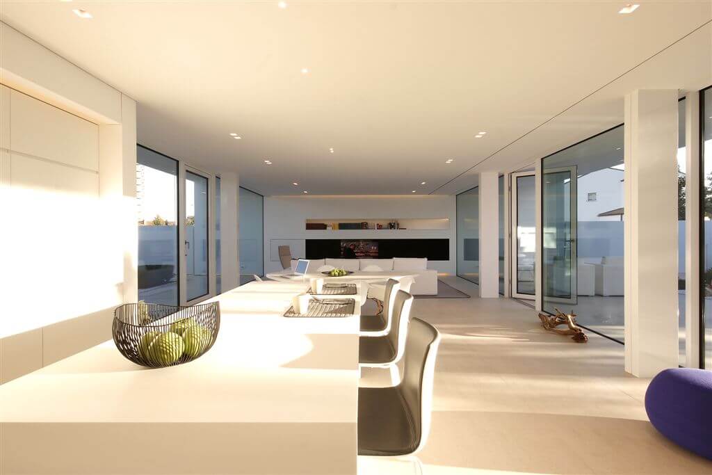 View over kitchen island toward front living room, highlighting small recessed light sources down length of entire area. View over kitchen island toward front living room, highlighting small recessed light sources down length of entire area.
