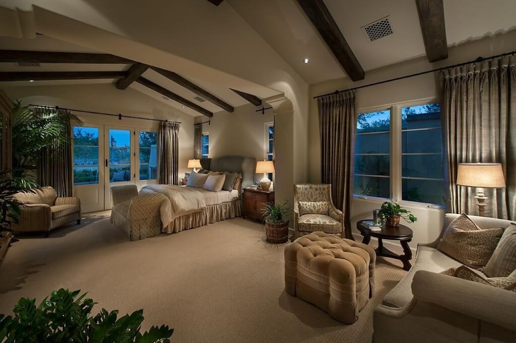 With a slight exposed wood-beamed cathedral ceiling, this large master bedroom suite is a true retreat from the rest of the home With a slight exposed wood-beamed cathedral ceiling, this large master bedroom suite is a true retreat from the rest of the home