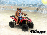 Sue and Luis riding a motorcar