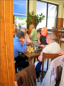 Older gentleman playing chess together