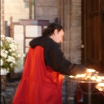 Dan Lighting a candle at Notre Dame