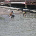 Boys playing in the river where we put our bus on the ferry on our way to Phnom Penh.