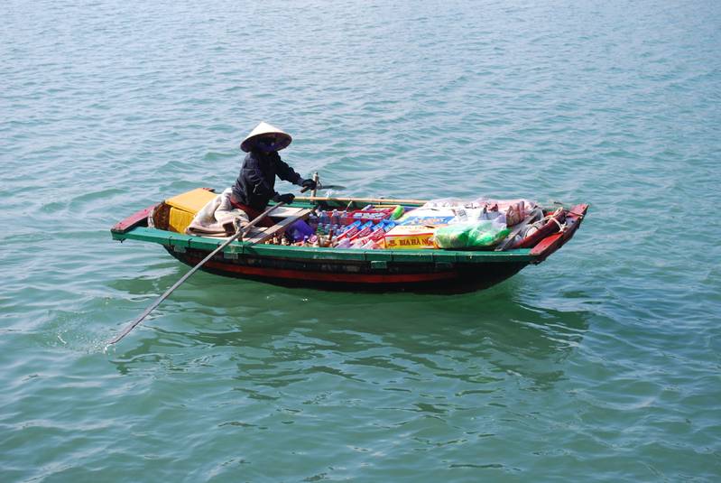 Local woman selling food and drinks to the passing boats, including our own boat