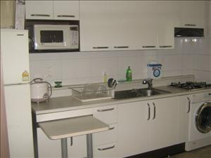This is the kitchen...  note the laundry machine under our gas stove.  there