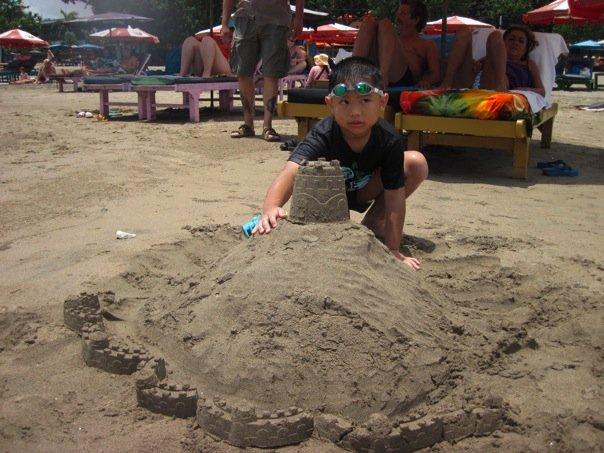 Built a sand castle on top of a "hill" for Bryan. When I came back to finish it later on, a couple dogs were pee-ing on it.