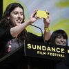 Alison Klayman accepts her Special Jury Prize, and takes a moment to snap a photo of the audience.
