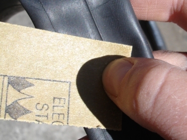 Sanding the tube helps the glue to stick the patch on