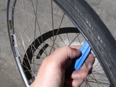 You may need a tyre lever to get the last section of tyre onto the rim