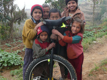 Nepalese kids marvel at a unicycle Nepalese kids marvel at a unicycle