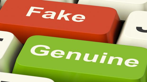 image of keys on a keyboard with the words fake and genuine on them