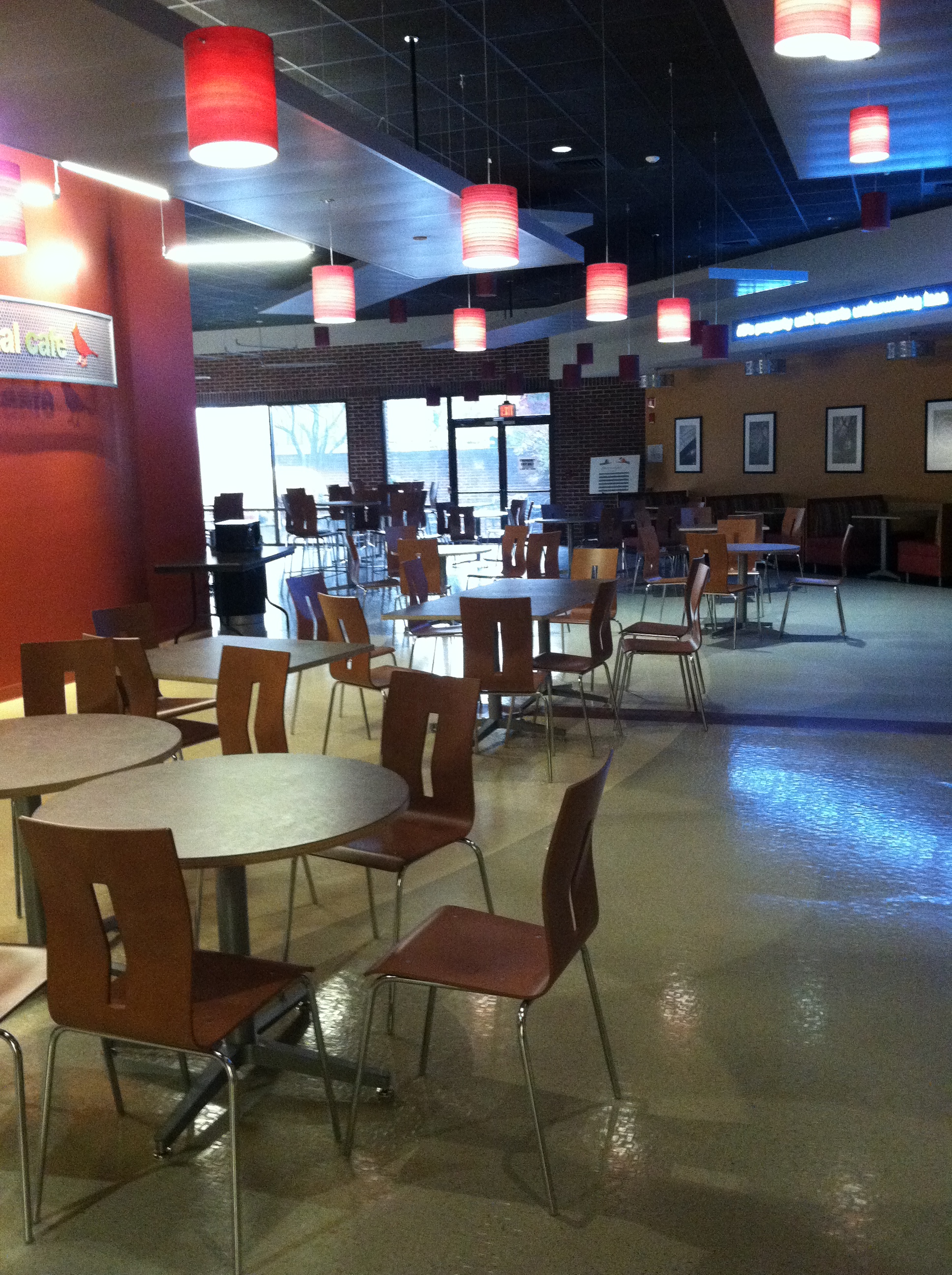 Cafeteria showing round tables, pendant lighting and laminate chairs
