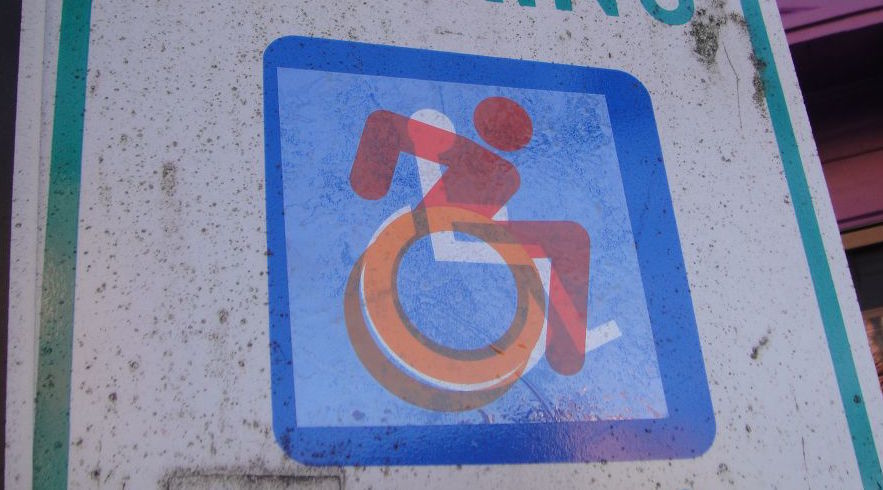 Graphic street intervention from The Accessible Icon Project. http://accessibleicon.org. Photo by Brian Funck