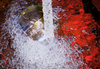 Tap Water Into a Glass Sink by Ken Iles