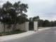 Gated entrance surrounded by trees at Woods of Alon