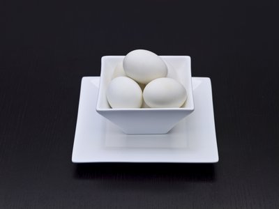 Fine Art Print of White duck eggs in a white bowl by Assaf Frank