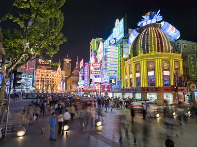 Fine Art Print of Neon sign with people on road at night, Nanjing Lu, Shanghai by Assaf Frank