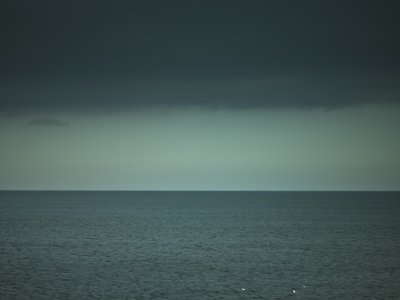 Fine Art Print of Sea view and grey clouds by Assaf Frank