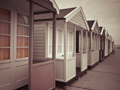 Fine Art Print of Multi coloured beach huts in a row by Assaf Frank