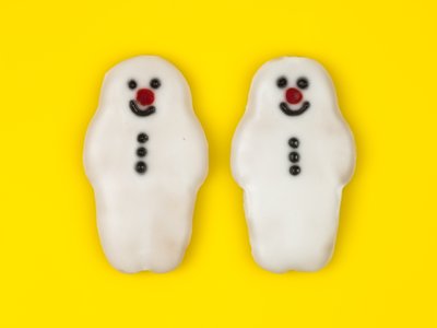Fine Art Print of Two gingerbread snowman on coloured background by Assaf Frank