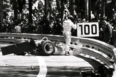1969 Spanish Grand Prix. Montjuich Park, Spain. 4 May 1969. Wing failure causes Graham Hill, Lotus 49B-Ford, to crash out, accident, action. by Anonymous - print