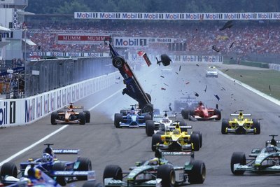 2001 German Grand Prix. Hockenheim, Germany. 27-29 July 2001. Luciano Burti (Prost AP04 Acer) flies through the air after he launched off of the back of Michael Schumacher's unsighted Ferrari F2001which was stuck in first gear. He landed just in front of Bernoldi's Arrows, but fortunately nobody was hurt in the accident. by Anonymous - print