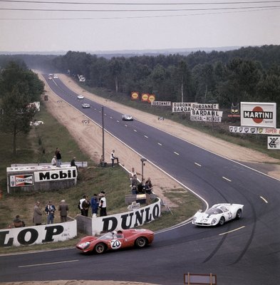 1967 Le Mans 24 hours. Le Mans, France. 10-11 June 1967. Chris Amon/Nino Vaccarella (Ferrari 330P4) lead at the Mulsanne Corner by Anonymous - print