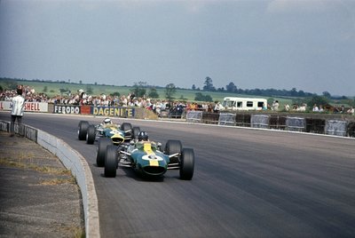1967 British GP, Silverstone, Graham Hill leads Jim Clark, both Lotus 49-Ford. Clark finished in 1st position by Anonymous - print