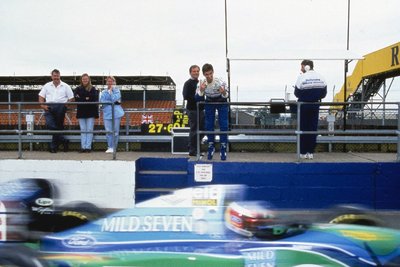 1994 Formula 1 testing, Silverstone, Damon Hill reacts to Michael Schumacher as he passes in the pitlane by Anonymous - print