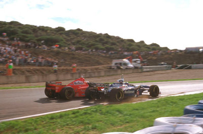 1997 European Grand Prix. Jerez, Spain. 24-26 October 1997. The moment the Drivers World Championship was decided, when Michael Schumacher (Ferrari F310B) turned into Jacques Villeneuve (Williams FW19 Renault) at the Curva Dry Sack. Jacques went on to take 3rd position and the title. by Anonymous - print
